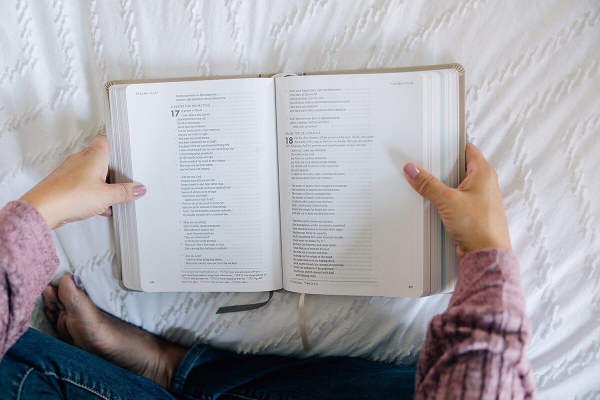 Anastasia holding open bible.