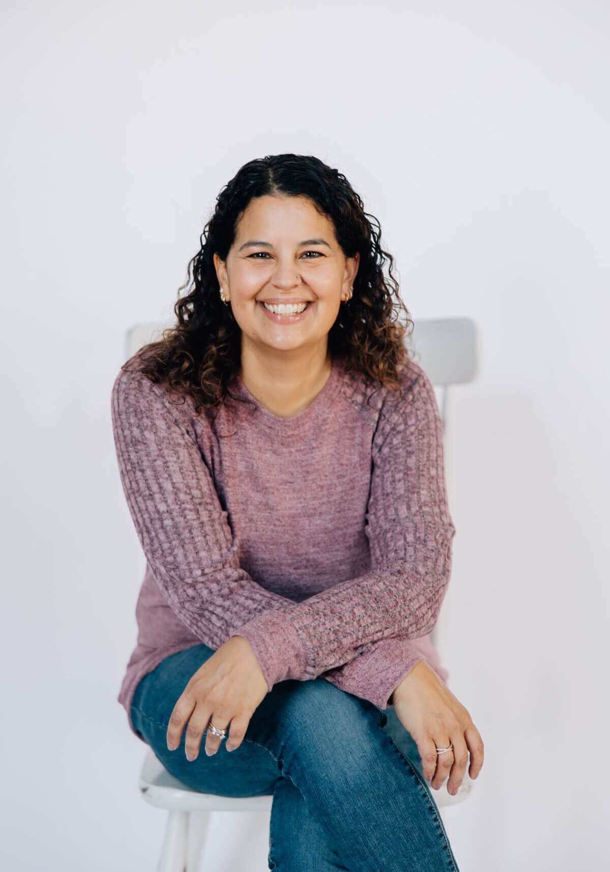 Anastasia Corbin Smiling and sitting