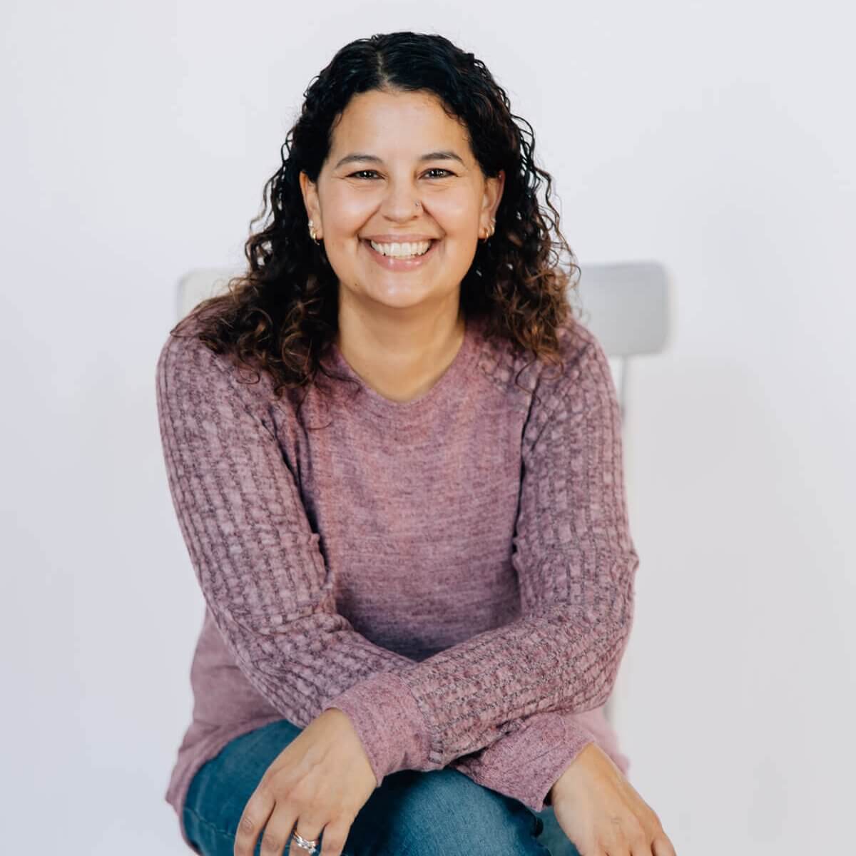 Anastasia Corbin Smiling and sitting